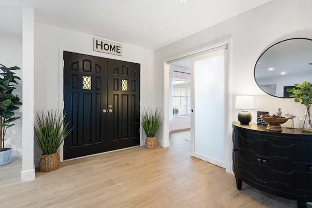 foyer entrance with light hardwood / wood-style floors