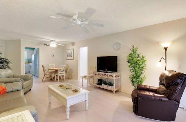 living room featuring ceiling fan and light carpet