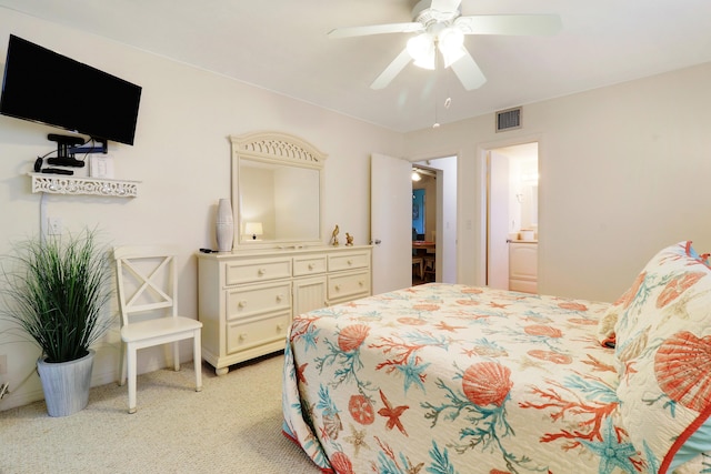 bedroom featuring ceiling fan, light carpet, and connected bathroom