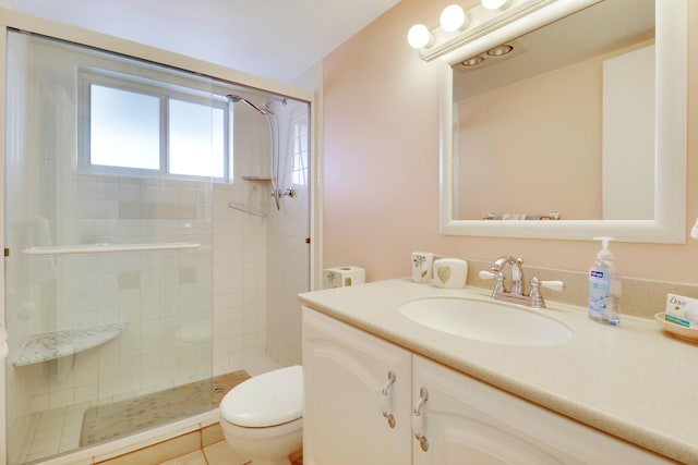 bathroom featuring tile patterned floors, toilet, vanity, and an enclosed shower