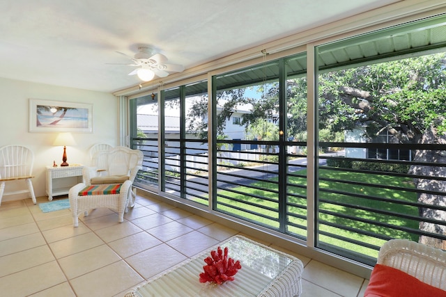 sunroom / solarium featuring ceiling fan