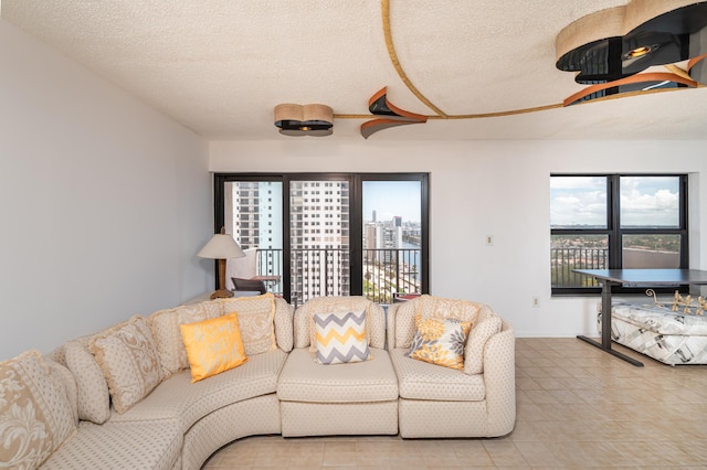 living room with a textured ceiling and a view of city