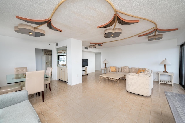 living room featuring visible vents and a textured ceiling