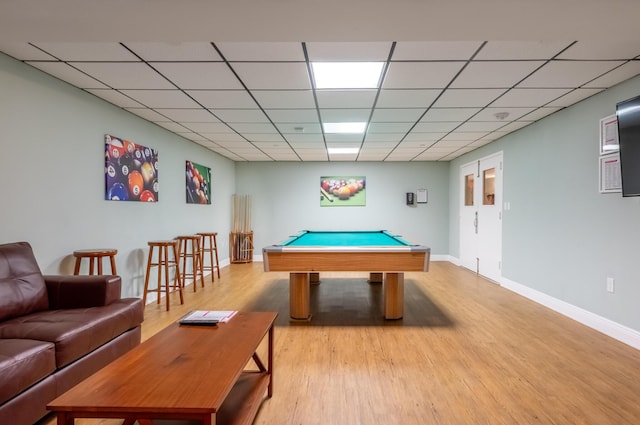 playroom featuring light wood-type flooring, pool table, a paneled ceiling, and baseboards