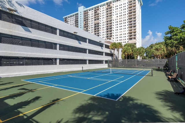 view of sport court featuring fence