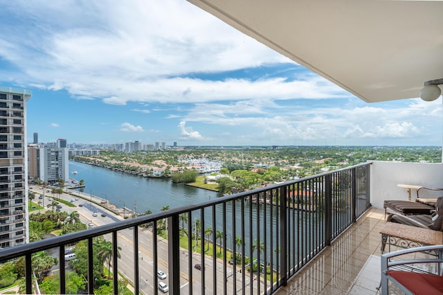 balcony featuring a water view and a city view