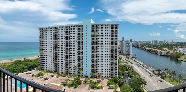 birds eye view of property with a water view and a view of city