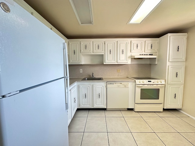 kitchen featuring white cabinets, white appliances, and light tile floors