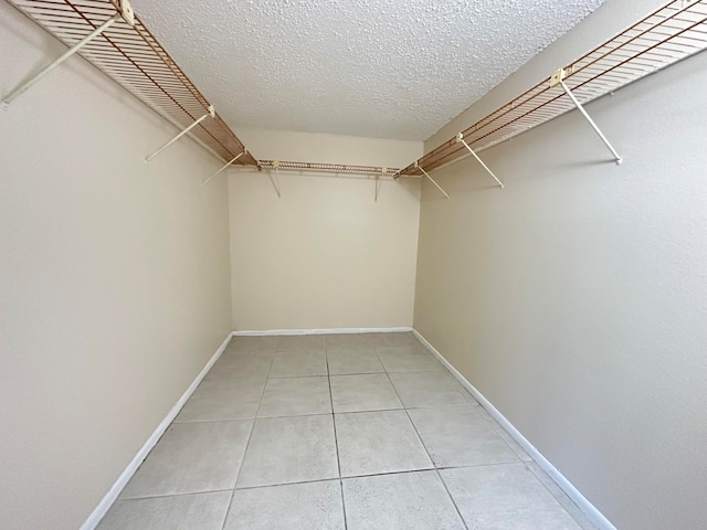 walk in closet featuring tile flooring