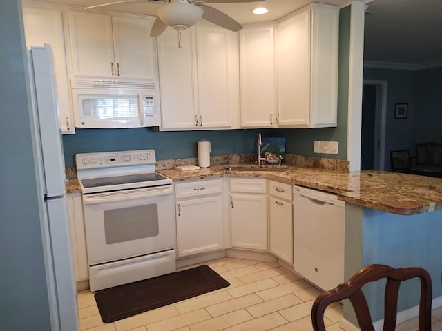 kitchen featuring white cabinets, sink, white appliances, and stone countertops