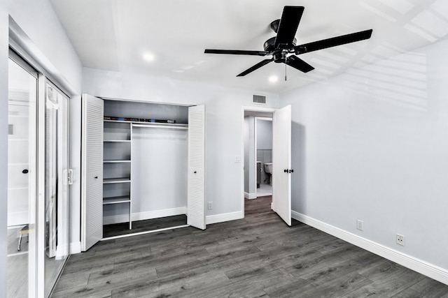 unfurnished bedroom with ceiling fan and dark hardwood / wood-style floors