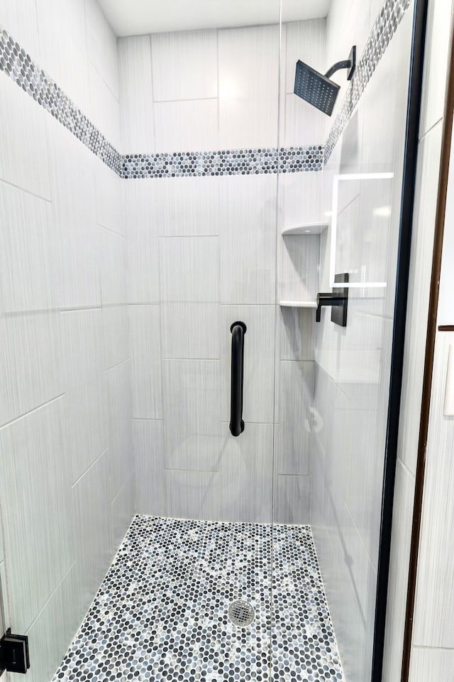 bathroom with a shower with door