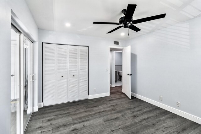 unfurnished bedroom featuring ceiling fan and dark hardwood / wood-style flooring