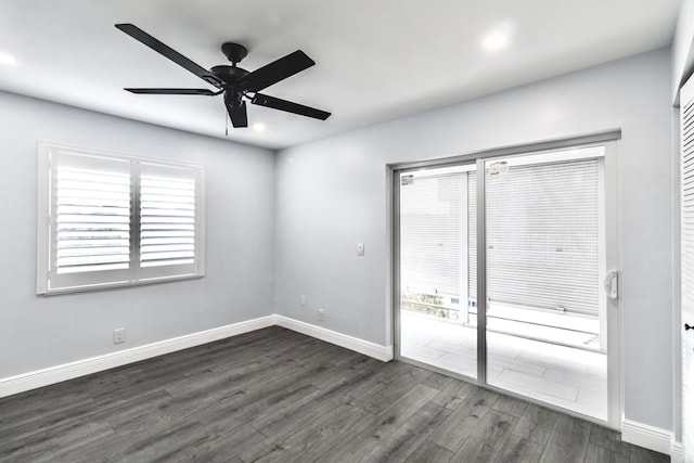 spare room with ceiling fan and dark wood-type flooring