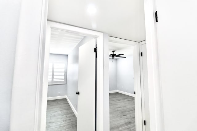 hallway with light hardwood / wood-style floors