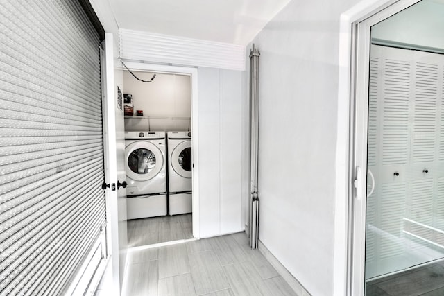 clothes washing area with washer and clothes dryer