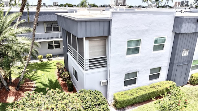 view of building exterior with a wall unit AC