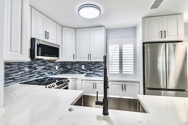 kitchen with white cabinets and stainless steel appliances