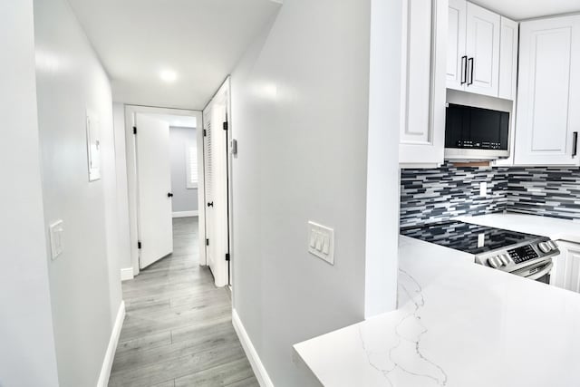 hallway with light hardwood / wood-style flooring