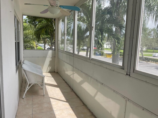 unfurnished sunroom with ceiling fan