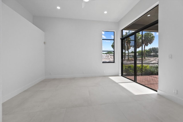 spare room featuring a wealth of natural light and ceiling fan