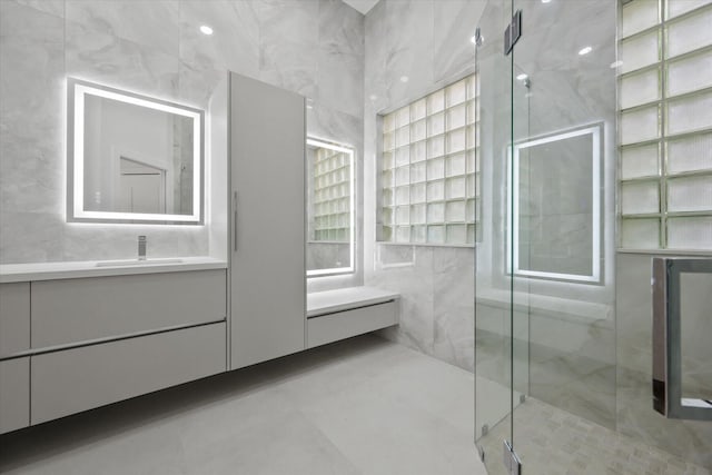 bathroom with vanity and a shower with shower door