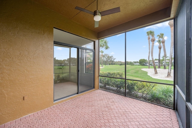 unfurnished sunroom with ceiling fan and a healthy amount of sunlight