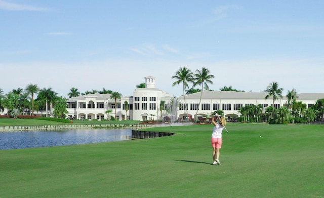 view of community with a water view and a lawn