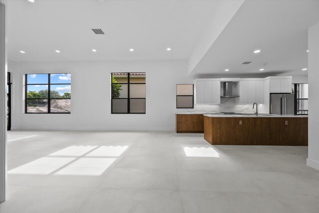 unfurnished living room featuring sink