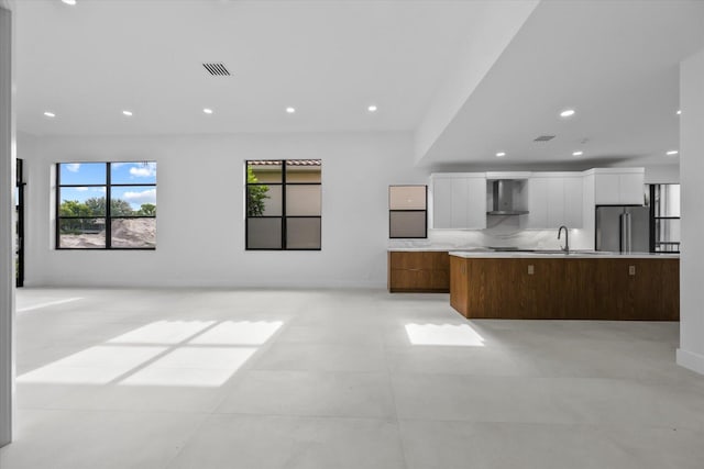 unfurnished living room featuring sink