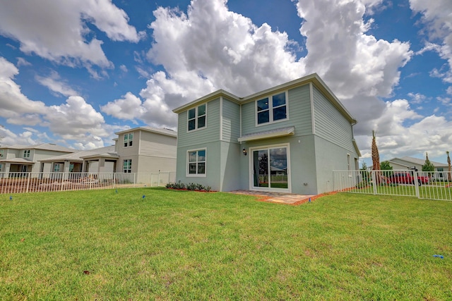 rear view of property with a lawn