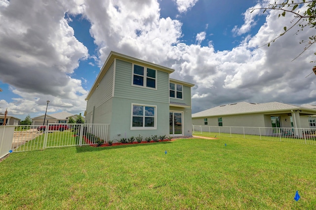 rear view of property featuring a yard