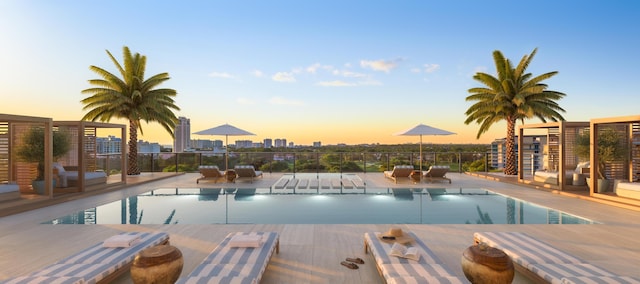 pool at dusk with a patio