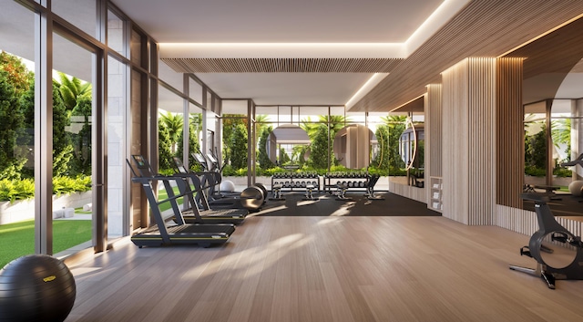 gym with a wall of windows and wood finished floors