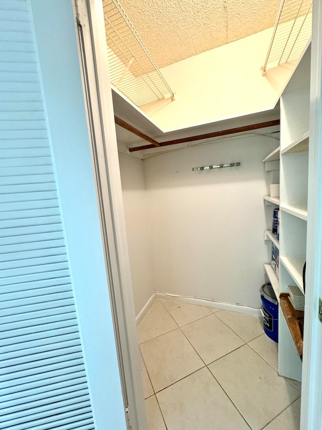 spacious closet with tile patterned flooring