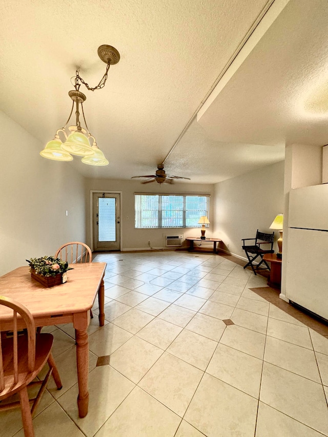 tiled dining room with a wall mounted air conditioner, a textured ceiling, and ceiling fan with notable chandelier