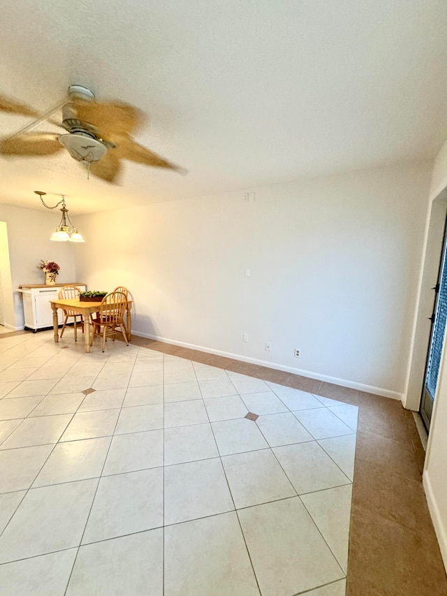 spare room with light tile patterned floors and ceiling fan