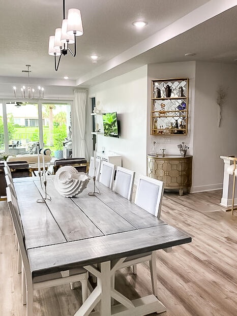 dining space with a chandelier and light hardwood / wood-style floors