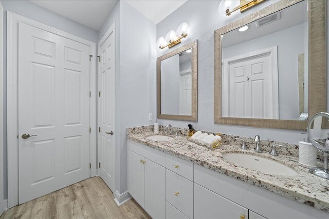 bathroom with wood-type flooring, a textured ceiling, an enclosed shower, and vanity