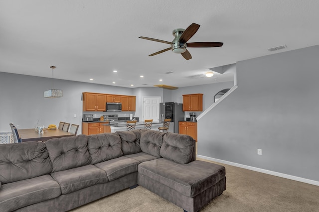 living room featuring ceiling fan and light carpet