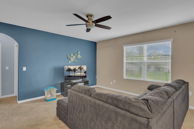 living room with ceiling fan and light colored carpet