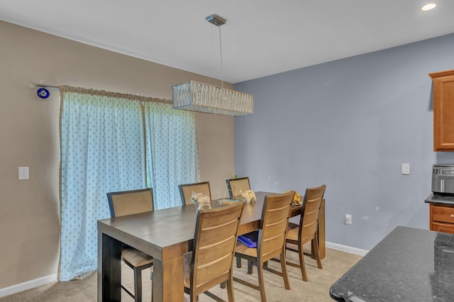 dining room featuring light carpet