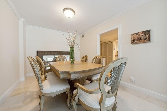 dining space featuring crown molding and light tile flooring