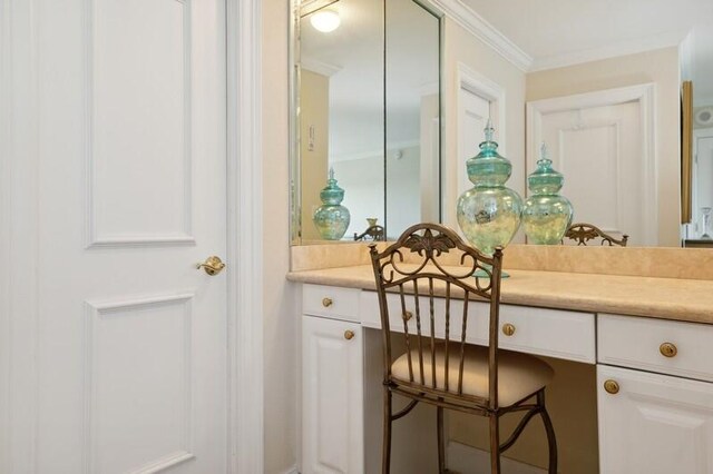 bedroom with ornamental molding and light colored carpet