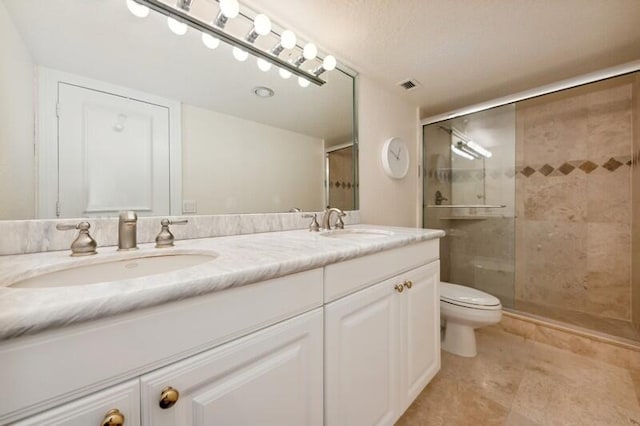 bathroom with tile floors, toilet, walk in shower, and double sink vanity