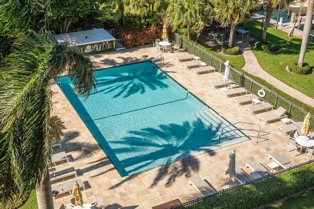 view of swimming pool featuring a patio and a yard