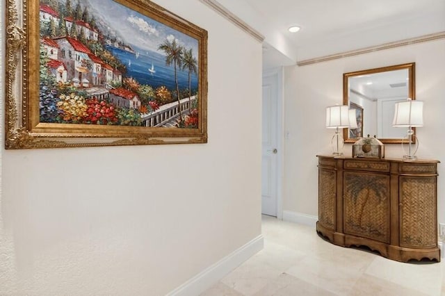 hallway featuring tile flooring and ornamental molding