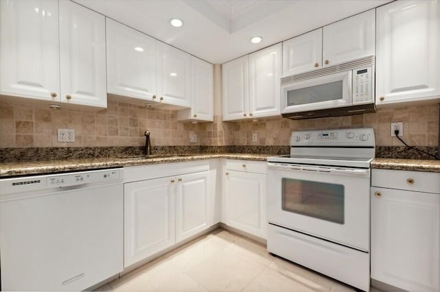 kitchen featuring sink, tasteful backsplash, white cabinets, and white appliances