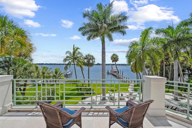 view of patio / terrace featuring a water view and a balcony