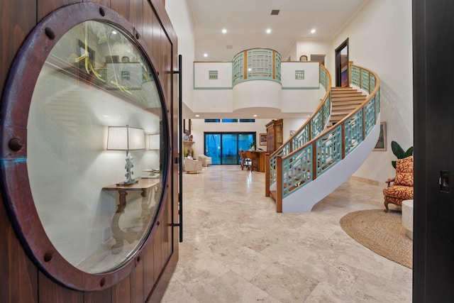 foyer featuring a high ceiling and ornamental molding